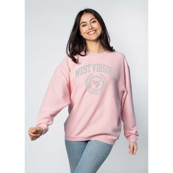 Model wearing the urban pink WVU chickad crew sweatshirt with West Virginia arched over a faux seal with the Flying WV Logo surrounded by laurel screen printed in a cool grey ink