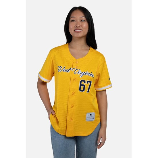 Front view of a model wearing the gold WVU women's button-up baseball jersey with West Virginia over 67