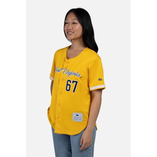 Side view of a model wearing the gold WVU women's button-up baseball jersey with West Virginia over 67