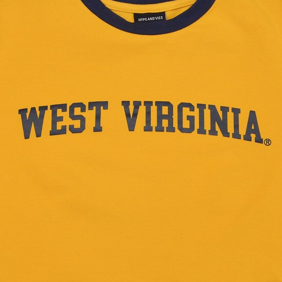 Close up of the West Virginia script in navy as the chest graphic on the gold WVU cropped long sleeve tee