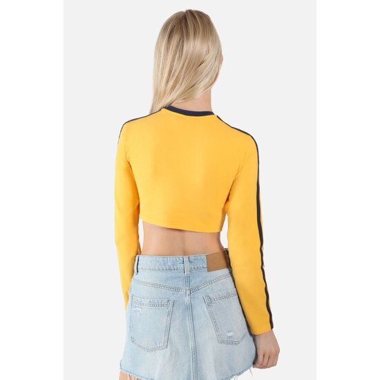 Back view of the model wearing the gold WVU cropped long sleeve tee with navy sleeve stripes and collar taping
