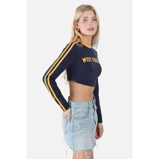 Side view of the model wearing the navy WVU cropped long sleeve tee with gold sleeve stripes and collar taping and West Virginia script in gold as the chest graphic