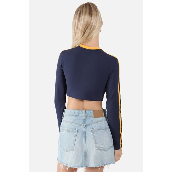 Back view of model wearing the navy WVU cropped long sleeve tee with gold sleeve stripes and collar taping and West Virginia script in gold as the chest graphic