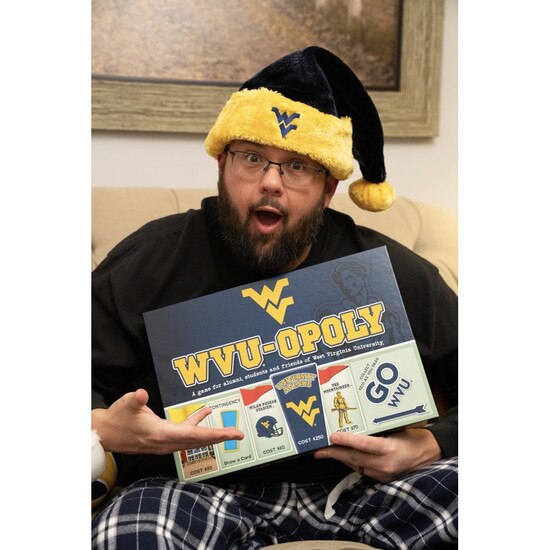 A father at Christmas excited that he received the WVU monopoly board game as his present