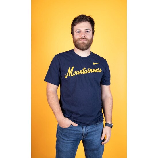 Model wearing the navy Nike WVU tee with Mountaineers diagonal script screenprint on the chest