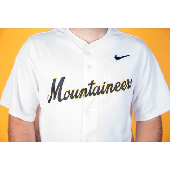 Close up of the full chest ultrastitch heat applied sublimated twill Mountaineers verbiage on the white Nike WVU baseball jersey
