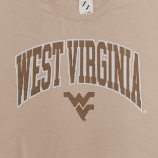 Close up of the West Virginia arched over a Flying WV as the front graphic of the sand WVU crop top