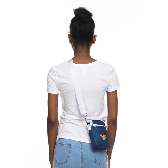 A model wearing the navy WVU cross body bag with a Flying WV Logo embroidery on front