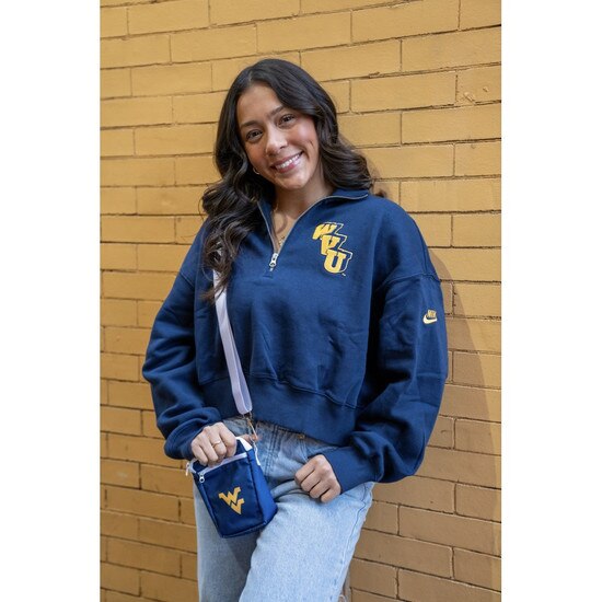 Our model wearing the navy WVU cross body bag with a Flying WV Logo embroidery on front along with the navy Nike WVU quarter zip crop pullover